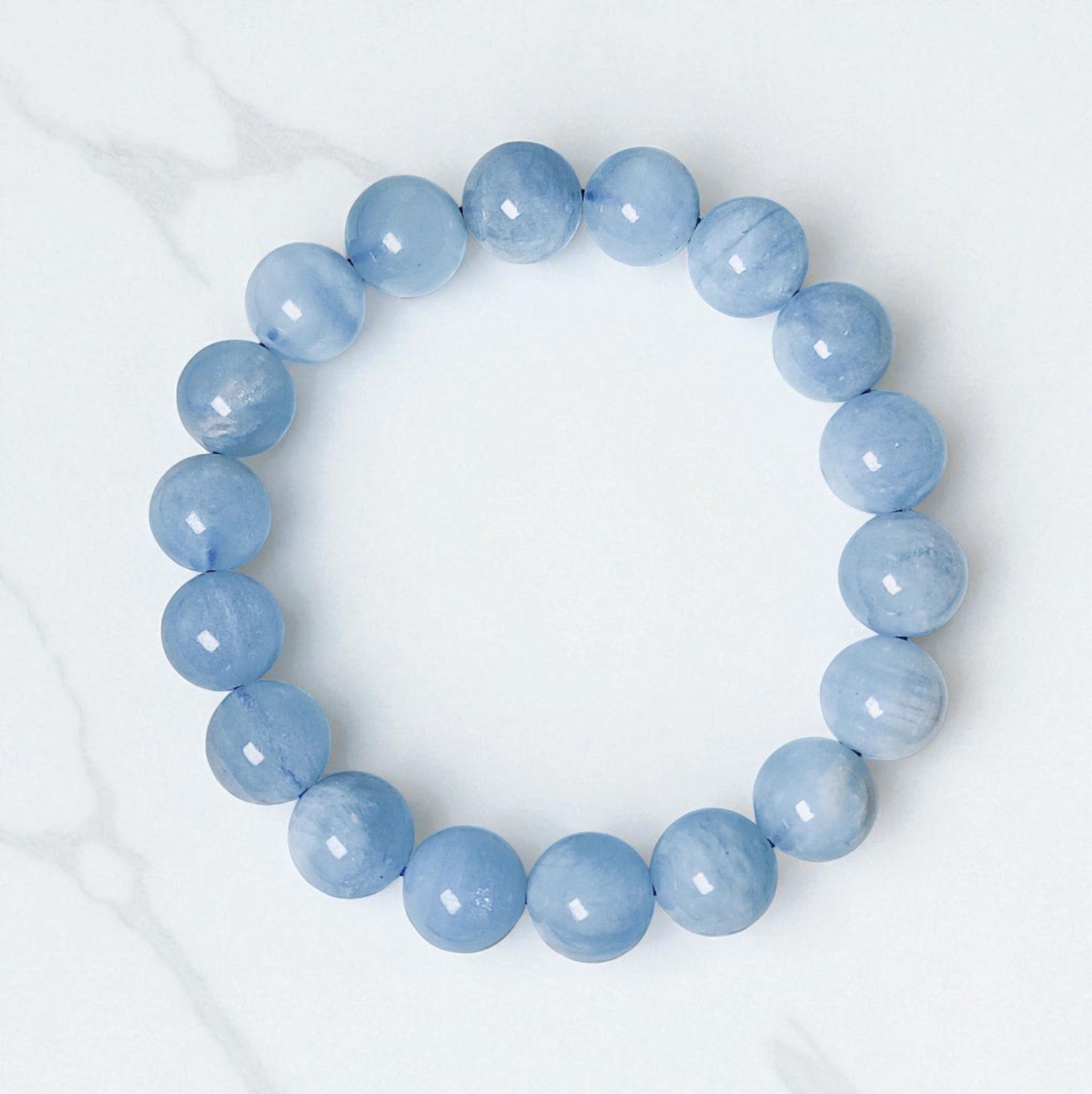 Blue beaded bracelet on a white background