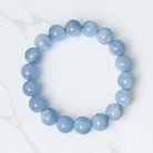 Blue beaded bracelet on a white background